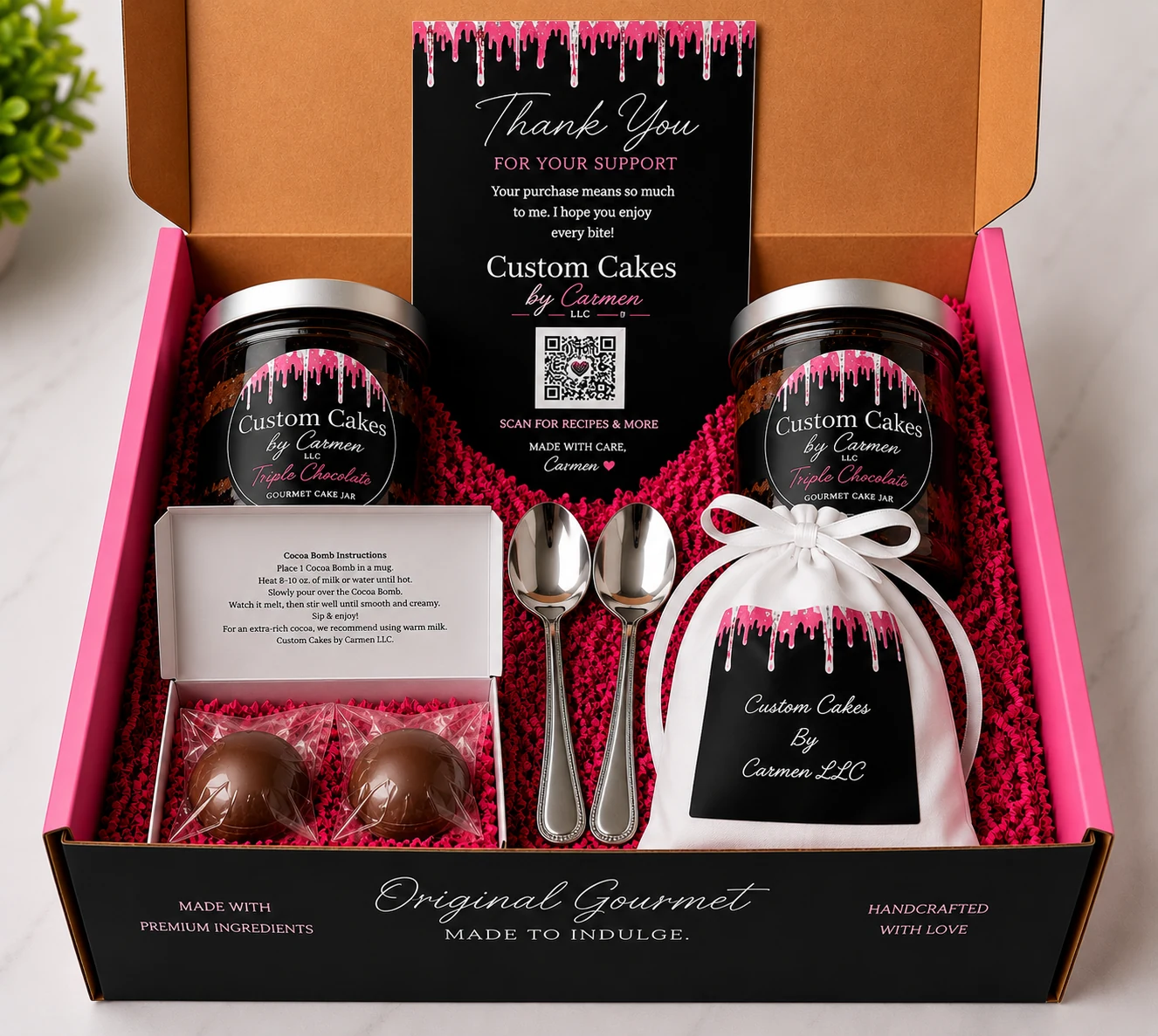Custom Cakes By Carmen gourmet gift box arranged in the brand's pink, black and silver presentation