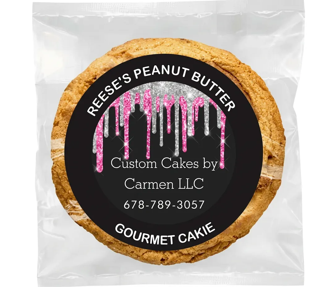 Reese's Peanut Butter Gourmet Cakie in a clear wrapper with the Custom Cakes By Carmen pink and silver drip label